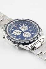 Load image into Gallery viewer, An angled close-up of a Breitling Jupiter Pilot watch, highlighting the blue dial, three white sub-dials, and the detailed markings on the bidirectional slide-rule bezel.