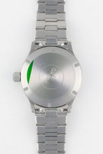 Load image into Gallery viewer, A direct view of the stainless steel case back, featuring the Omega logo in the center and a partial green protective sticker on the left edge.