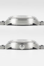 Load image into Gallery viewer, Two side-profile views of the watch case. The top view shows the smooth side, while the bottom view shows the screw-down crown embossed with the Omega logo.