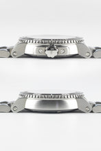 Load image into Gallery viewer, Two horizontal side-profile views of an Oris Aquis Date watch case; the top shows the "ORIS" signed crown and guards, while the bottom shows the smooth, brushed steel side profile.
